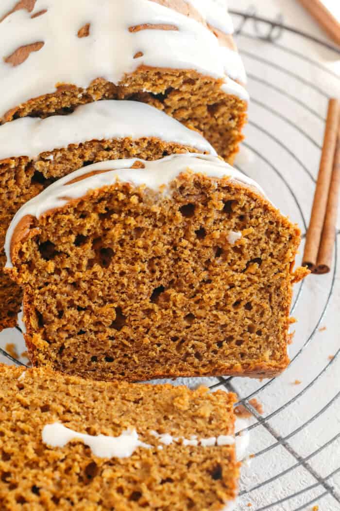 The BEST Healthy Pumpkin Bread that is moist, loaded with pumpkin flavor and made without any butter or refined sugar!  Topped with a delicious maple cream cheese glaze for the perfect fall treat this season!