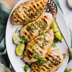 This Cilantro Lime Grilled Chicken Recipe is packed with so much zesty flavor and easily made with just a few simple ingredients! A delicious, healthy meal you can serve in tacos, on salads or over rice.